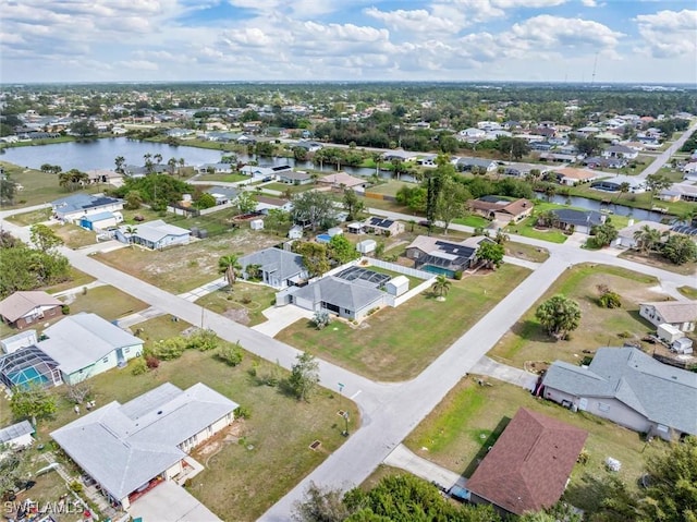 bird's eye view with a water view and a residential view