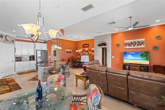 living room featuring recessed lighting, visible vents, and ornamental molding