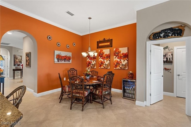 dining room featuring arched walkways, crown molding, baseboards, and an inviting chandelier