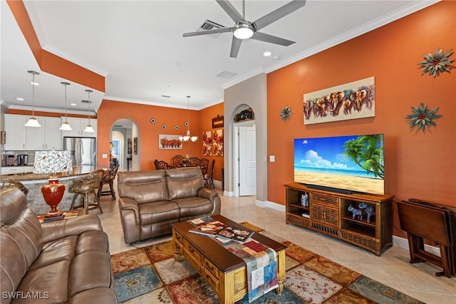 living room featuring ornamental molding, arched walkways, and baseboards