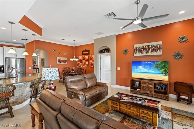 living room with visible vents, arched walkways, baseboards, ceiling fan, and ornamental molding