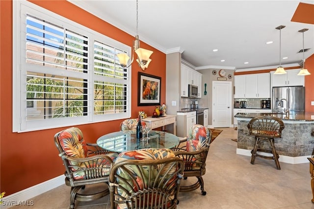 dining room with a chandelier, baseboards, visible vents, and crown molding