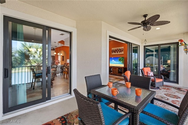 view of patio with outdoor dining space and ceiling fan