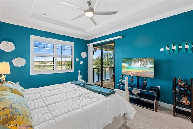 carpeted bedroom with access to exterior, crown molding, a raised ceiling, a ceiling fan, and baseboards