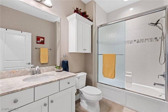 bathroom with toilet, shower / bath combination with glass door, and vanity