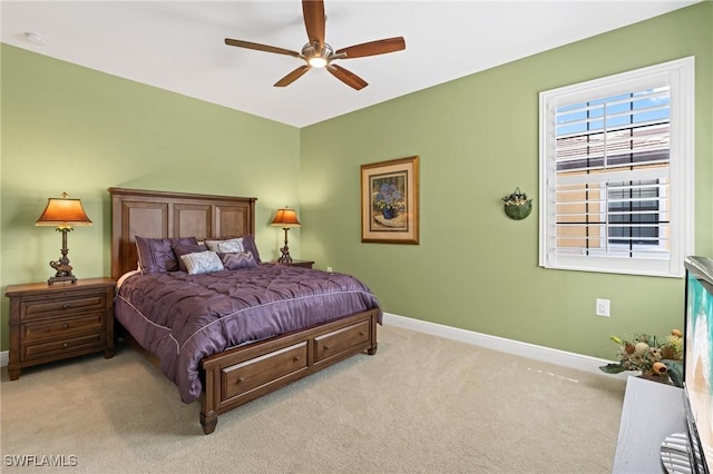 carpeted bedroom with a ceiling fan and baseboards