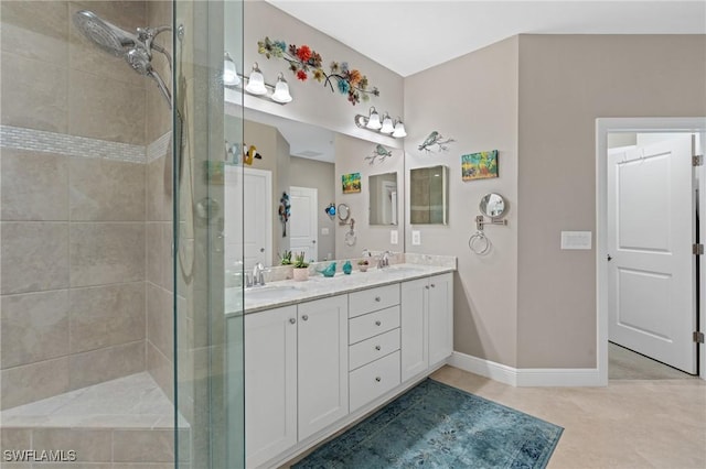 full bathroom featuring a sink, a shower stall, baseboards, and double vanity