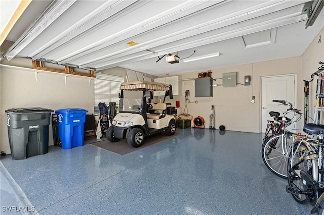 garage with electric panel and a garage door opener