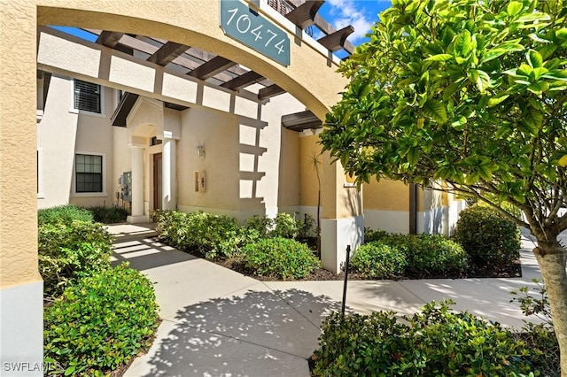 entrance to property featuring stucco siding