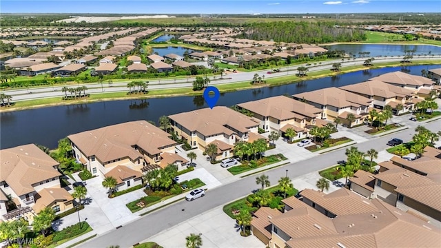 bird's eye view with a water view and a residential view