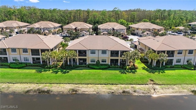 birds eye view of property with a water view, a forest view, and a residential view