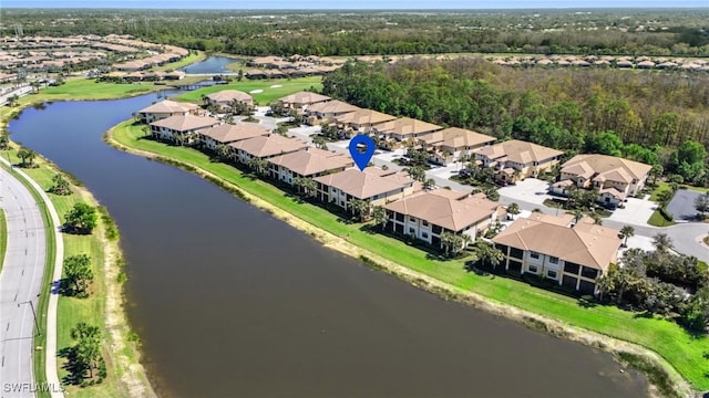 birds eye view of property with a water view and a residential view