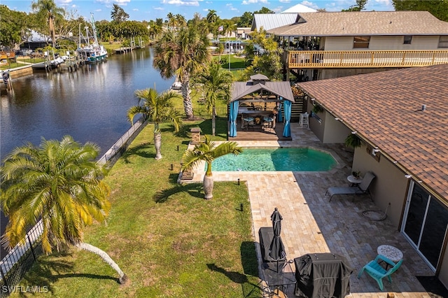 pool featuring a deck with water view, a patio area, a lawn, and a gazebo