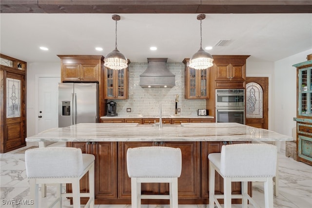 kitchen with tasteful backsplash, visible vents, marble finish floor, custom exhaust hood, and stainless steel appliances