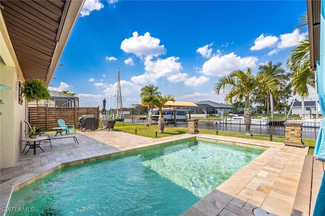 view of pool with glass enclosure, a grill, fence, a fenced in pool, and a patio area