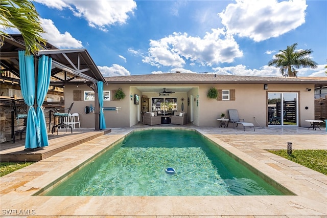 view of pool with a patio area, ceiling fan, and an outdoor hangout area