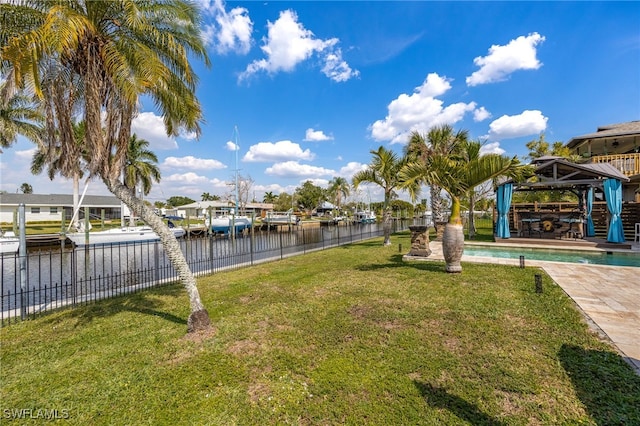 view of yard featuring fence, a fenced in pool, and a gazebo