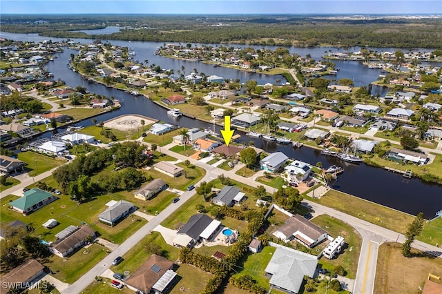 birds eye view of property featuring a water view and a residential view