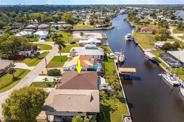 drone / aerial view featuring a water view and a residential view