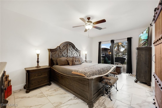 bedroom featuring marble finish floor, a barn door, a ceiling fan, and access to exterior