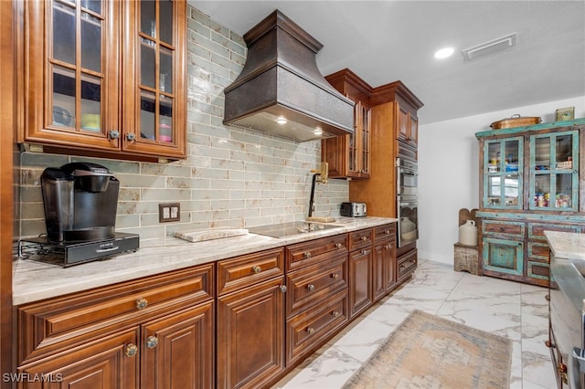 kitchen with tasteful backsplash, visible vents, custom range hood, marble finish floor, and black electric stovetop