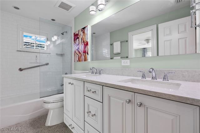 bathroom with double vanity, speckled floor, a sink, and visible vents