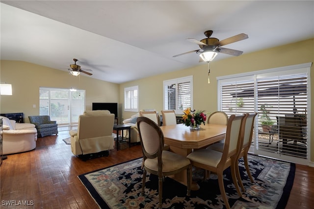 dining space featuring vaulted ceiling, dark wood-style flooring, and a ceiling fan