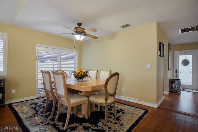 dining room with visible vents, baseboards, and wood finished floors