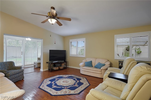 living area with lofted ceiling, wood finished floors, a ceiling fan, and baseboards