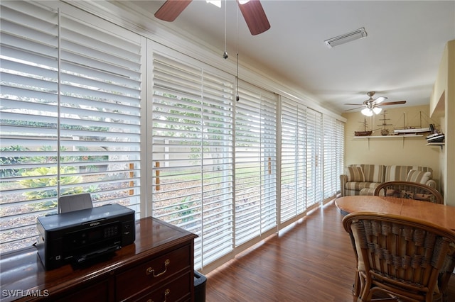 interior space featuring visible vents, ceiling fan, and wood finished floors