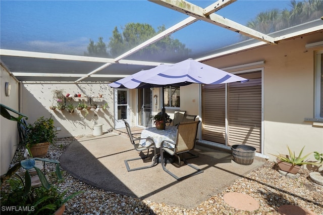 view of patio with glass enclosure