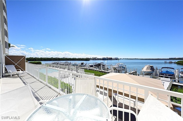 balcony featuring a water view and a boat dock
