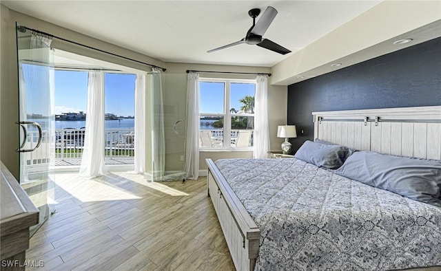 bedroom with baseboards, light wood-style flooring, ceiling fan, and access to outside