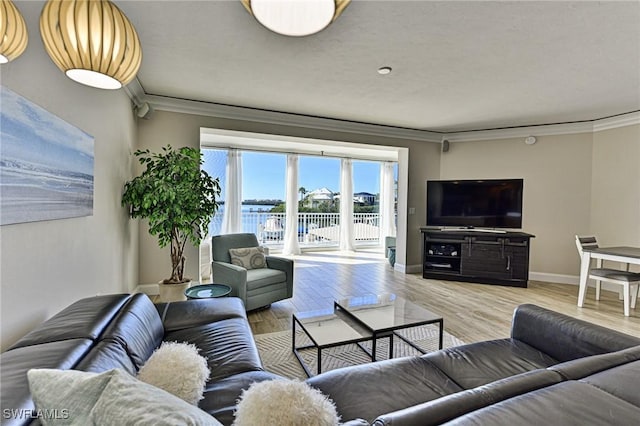 living room with baseboards, wood finished floors, and crown molding