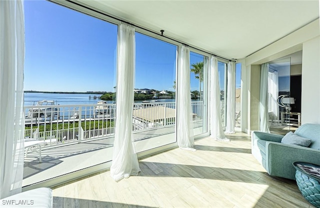 sunroom / solarium with a water view