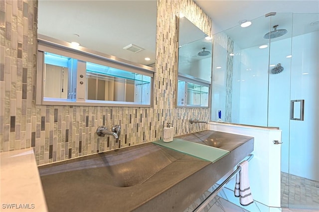 full bathroom with visible vents, a shower stall, and tasteful backsplash