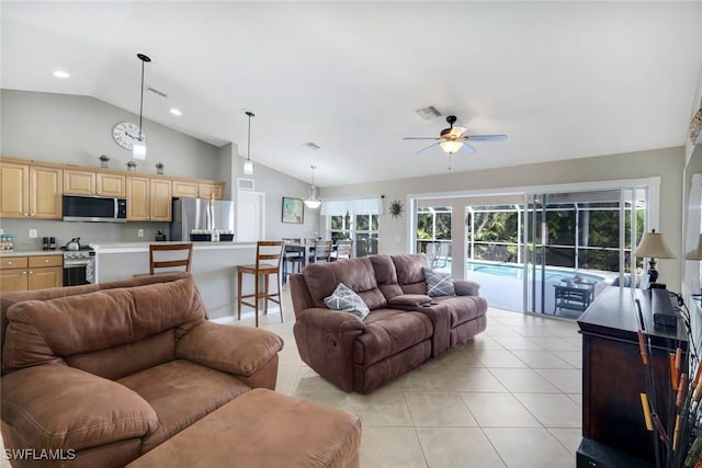 living area with a ceiling fan, a wealth of natural light, visible vents, and light tile patterned floors