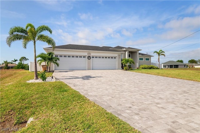 view of front of home featuring a front yard, decorative driveway, an attached garage, and stucco siding