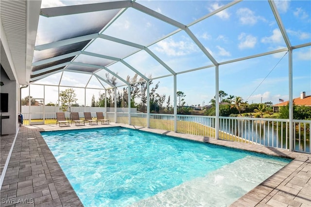 view of swimming pool with a lanai, a water view, a fenced in pool, and a patio