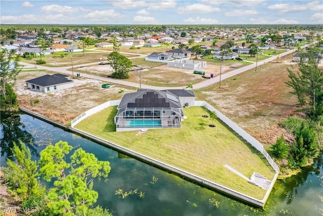 drone / aerial view with a water view and a residential view