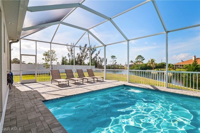 view of pool featuring a lanai, a water view, fence, a fenced in pool, and a patio area