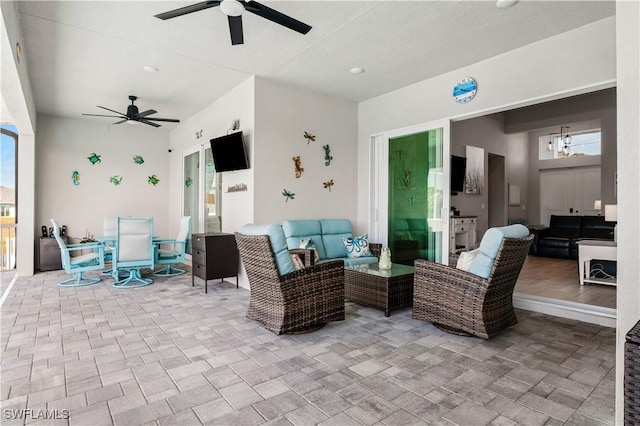 view of patio / terrace featuring outdoor dining area, an outdoor living space, and a ceiling fan