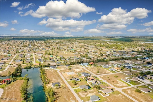 drone / aerial view featuring a water view and a residential view