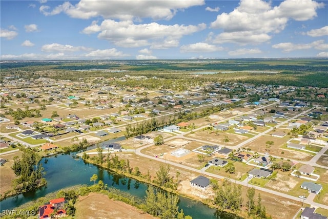 drone / aerial view with a water view and a residential view