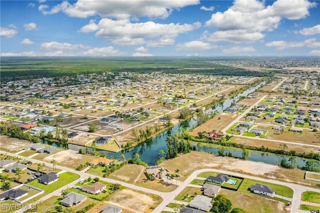 drone / aerial view featuring a water view and a residential view