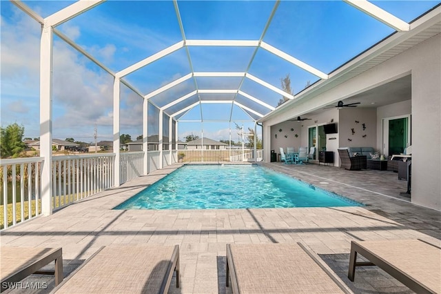 view of pool with a ceiling fan, a lanai, a patio area, and a fenced in pool