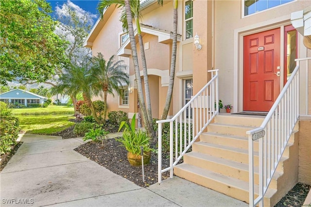 doorway to property with stucco siding