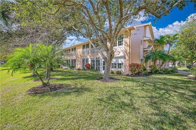 view of front of home with a front lawn and stucco siding