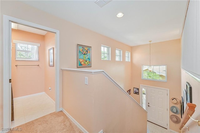 foyer with light tile patterned floors, baseboards, visible vents, and recessed lighting