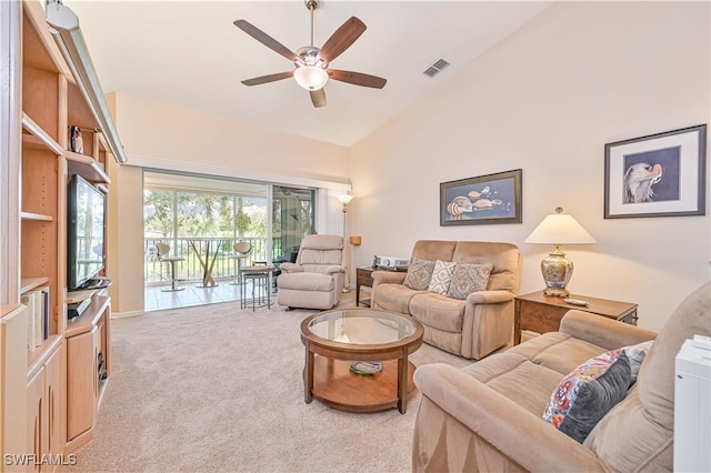 living room featuring high vaulted ceiling, light colored carpet, visible vents, and ceiling fan